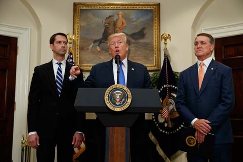 President Donald Trump- RAISE Act (Image Source: The Atlantic) President Donald Trump, flanked by Senators Tom Cotton, left, and David Perdue, speaks in the Roosevelt Room of the White House on August 2, 2017, during the unveiling of the RAISE Act. crowdink.com, crowdink.com.au, crowdink, crowd ink